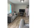 Inviting living room features sleek furniture, a fireplace, and wood-look flooring at 307 S Smithfield Rd, Knightdale, NC 27545