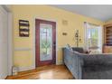 Inviting living room showcasing hardwood floors, decorative front door, and a cozy ambiance at 342 Mcleod Rd, Broadway, NC 27505