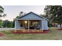 Inviting front porch featuring comfortable seating, perfect for relaxing outdoors at 3610 Hawkins Ave, Sanford, NC 27330