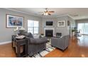 Cozy living room with hardwood floors, fireplace, ceiling fan, and comfortable seating at 3827 Heritage Spring Circle Cir, Wake Forest, NC 27587