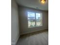 Bright bedroom with neutral carpet and a large window offering scenic neighborhood views at 40 Wabash St, Pittsboro, NC 27312