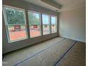 Bedroom with three large windows letting in natural light and trey ceiling at 40 Wabash St, Pittsboro, NC 27312