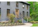 Elegant home featuring a stylish entrance with a detailed doorway and manicured landscaping at 401 Brinkman Ct, Raleigh, NC 27614