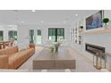 Open-concept living area with a modern fireplace, leading to a dining area and outdoor views at 401 Brinkman Ct, Raleigh, NC 27614