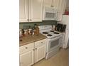 Kitchen showcasing white cabinetry and standard appliances at 407 N Cheatham St, Franklinton, NC 27525