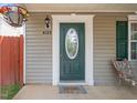 Charming front door with decorative glass, sidelight, and hanging flower basket for a welcoming entrance at 4125 Palafox Ct, Raleigh, NC 27604