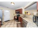 Well-lit kitchen featuring granite countertops, stainless steel appliances, and decorative tile flooring at 4125 Palafox Ct, Raleigh, NC 27604