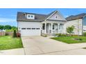 Charming home featuring a welcoming front porch and a well-maintained lawn with pretty landscaping at 4333 Benton Mill Dr, Fuquay Varina, NC 27526