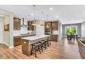 Spacious kitchen with stainless appliances, a large island with bar stool seating, and ample lighting at 4333 Benton Mill Dr, Fuquay Varina, NC 27526