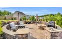 Outdoor patio with custom stone work, ample seating, fire pit, and outdoor kitchen at 4333 Benton Mill Dr, Fuquay Varina, NC 27526