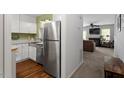 Modern kitchen with stainless steel appliances, white cabinets, and convenient layout open to the living area at 4617 Fawnbrook Cir, Raleigh, NC 27612