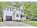 Two-story home with a garage and front porch with swing on landscaped lot at 4711 Buttonbush Dr, Durham, NC 27712