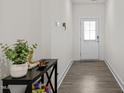 Welcoming entryway with hardwood flooring and decorative table at 484 Autumn Rain St, Cary, NC 27519