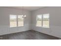 Dining room featuring hardwood floors, wainscoting, and natural light at 50 Watermelon Dr, Franklinton, NC 27525