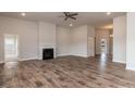 Spacious living room featuring hardwood floors, fireplace, and ample natural light at 50 Watermelon Dr, Franklinton, NC 27525