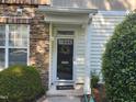 Inviting front entrance with stone accents, black front door, and a welcoming mat at 5033 Amber Clay Ln, Raleigh, NC 27612