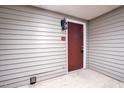 A-1 Entrance door with dark wood-look door and matching sconce at 505 Gooseneck Dr # A1, Cary, NC 27513