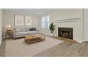 Cozy living room features a fireplace, neutral decor, and wood-look flooring at 505 Gooseneck Dr # A1, Cary, NC 27513