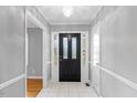Welcoming foyer with tile flooring and a stylish front door, creating a great first impression at 515 Oakwood Ln, Graham, NC 27253