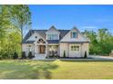 Beautiful two-story home boasts a brick facade, gabled roof, and a well-manicured lawn at 669 Balmoral St, Clayton, NC 27520