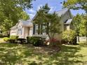 Beautifully landscaped home with a tidy front yard, and charming architectural design at 6715 St Johns Ct, Raleigh, NC 27616