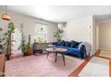 Cozy living room featuring a plush blue sofa and natural light at 7313 Longstreet Dr, Raleigh, NC 27615