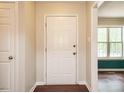 Bright entryway featuring neutral walls, wood-look floors, and a view into the living area at 81 Sallie Dr, Smithfield, NC 27577