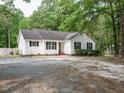 Charming single-story home featuring a white exterior, black shutters, and well-maintained landscaping at 81 Sallie Dr, Smithfield, NC 27577