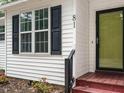 Close up view of the exterior with black shutters and red steps leading to the front door at 81 Sallie Dr, Smithfield, NC 27577