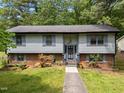 Inviting front exterior with light siding, brick foundation, and well-maintained walkway at 820 Nuttree Pl, Raleigh, NC 27606
