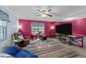 Comfortable living room with a large television and cozy seating, bathed in warm light at 820 Nuttree Pl, Raleigh, NC 27606