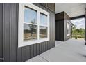 Close-up showcasing the home's exterior with clean lines, modern windows, and a well-kept concrete walkway at 8629 Dukes Lake Rd, Zebulon, NC 27597