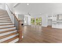 Open-concept living room showcases hardwood floors, fireplace and seamless access to a covered deck at 9309 Field Maple Ct, Raleigh, NC 27613