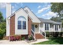Traditional home boasting brick accents, fresh landscaping, and a light blue front door at 9404 Dawnshire Rd, Raleigh, NC 27615