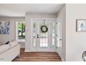Bright entryway with decorative glass door and wood-look floors at 106 Circle Dr, Mebane, NC 27302