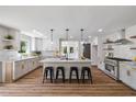 Renovated kitchen with stainless steel appliances, marble countertops, and a breakfast bar with seating at 106 Circle Dr, Mebane, NC 27302