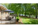 Spacious patio with outdoor seating and serene lake views at 116 Hibiscus Dr, Clayton, NC 27527