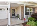 Inviting front porch with space for seating and brick accent, enhancing the home's curb appeal at 1230 Sunday Silence Dr, Knightdale, NC 27545