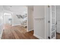 Bright hallway featuring hardwood floors, white walls, and an open view to the dining area at 1230 Sunday Silence Dr, Knightdale, NC 27545