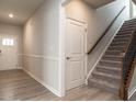 Bright foyer with hardwood floors, staircase, and access to various rooms at 1242 Underbrush Dr, Durham, NC 27703