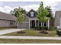 Attractive home with a neat front lawn, a two-car garage, and a welcoming entrance at 1242 Underbrush Dr, Durham, NC 27703