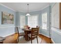 Cozy breakfast nook with a round table, four chairs, and a bay window for natural light at 1276 Dalgarven Dr, Apex, NC 27502
