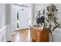 Bright foyer with hardwood floors, a decorative console table, and a view of the front door at 1276 Dalgarven Dr, Apex, NC 27502
