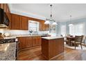 Spacious kitchen with granite countertops, stainless steel appliances, a center island, and a breakfast nook at 1276 Dalgarven Dr, Apex, NC 27502