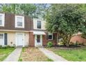Attractive townhouse with a combination of siding and brick facade and a well-maintained lawn at 13 Patriot Cir, Durham, NC 27704