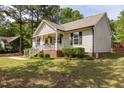 Well-maintained single-Gathering home showcasing the side and front, with a manicured lawn and mature trees at 14 Shire Ct, Zebulon, NC 27597