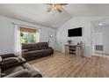 Bright living room featuring hardwood floors, a ceiling fan, a TV, and lots of natural light at 14 Shire Ct, Zebulon, NC 27597