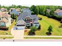 Gorgeous two-story home featuring manicured landscaping and a large, pristine lawn at 1429 Wragby Ln, Apex, NC 27502