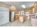 Spacious kitchen with light wood cabinets, granite countertops, an island, and stainless steel appliances at 146 Rockport Ridge Way, Cary, NC 27519