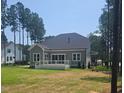 Spacious backyard with a deck, lush lawn, and mature trees offering privacy at 15 Independence Dr, Smithfield, NC 27577